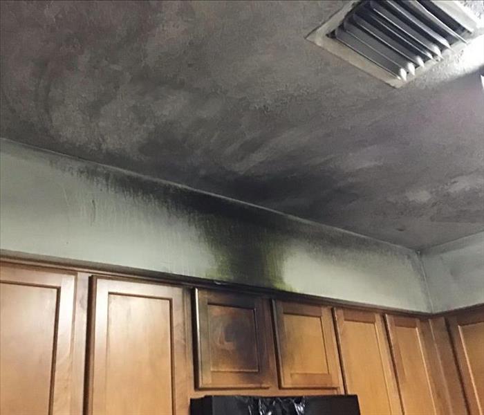 sooty deposits on cabinets and ceiling
