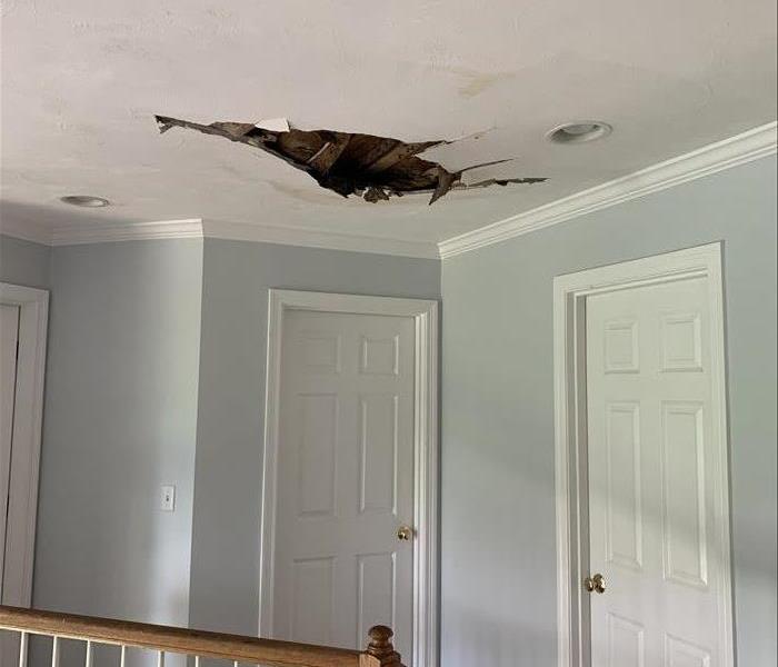 hole shown in ceiling, second story, white door